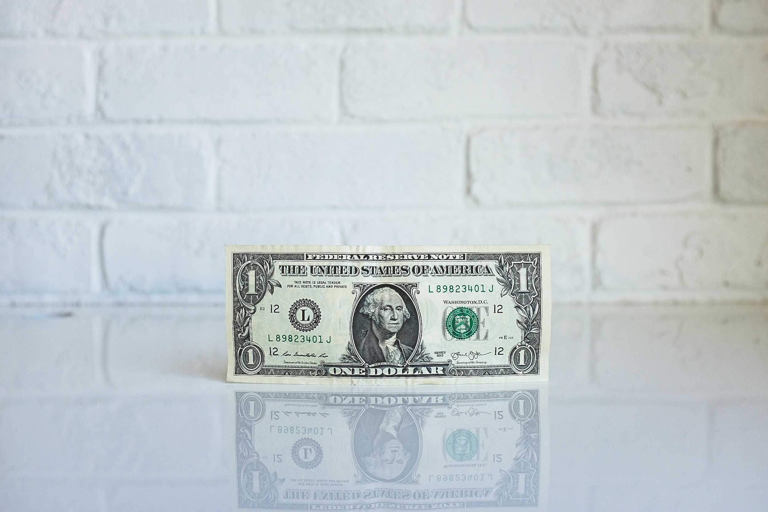 Dollar bill on counter to symbolize doubling your income on Upwork
