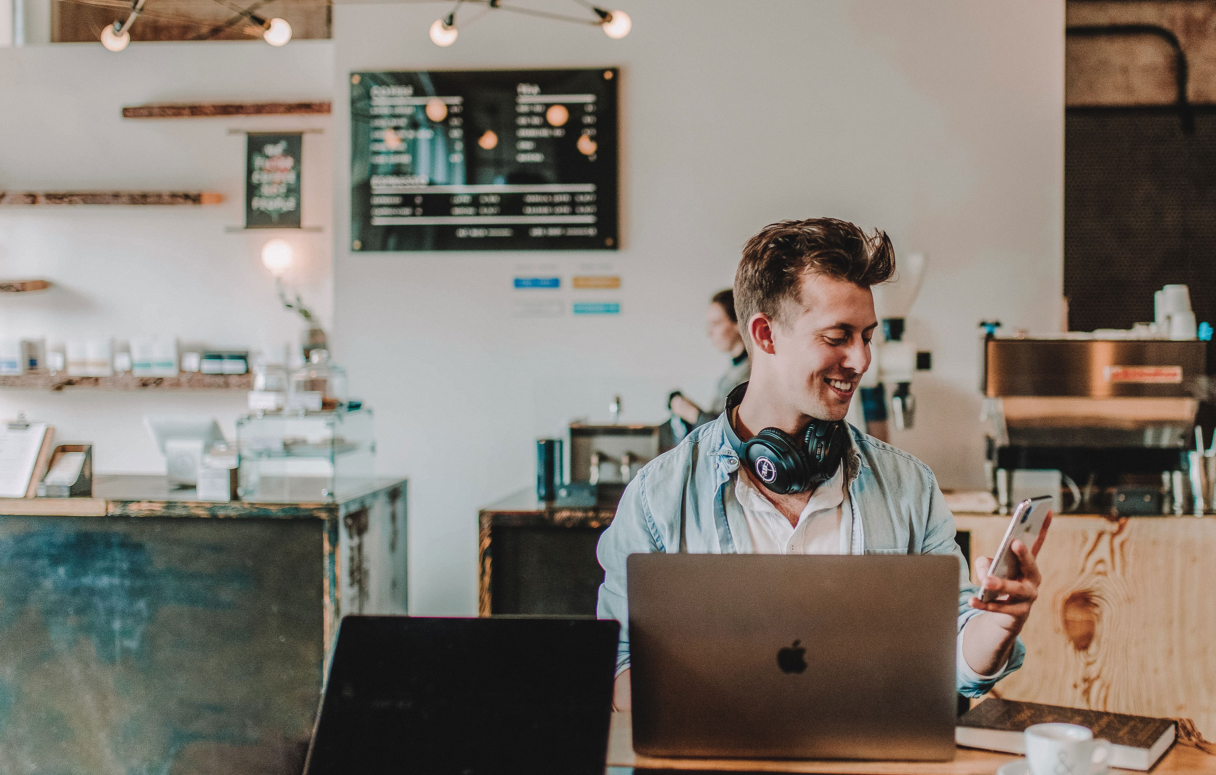 Man sitting in coffee shop working on computer