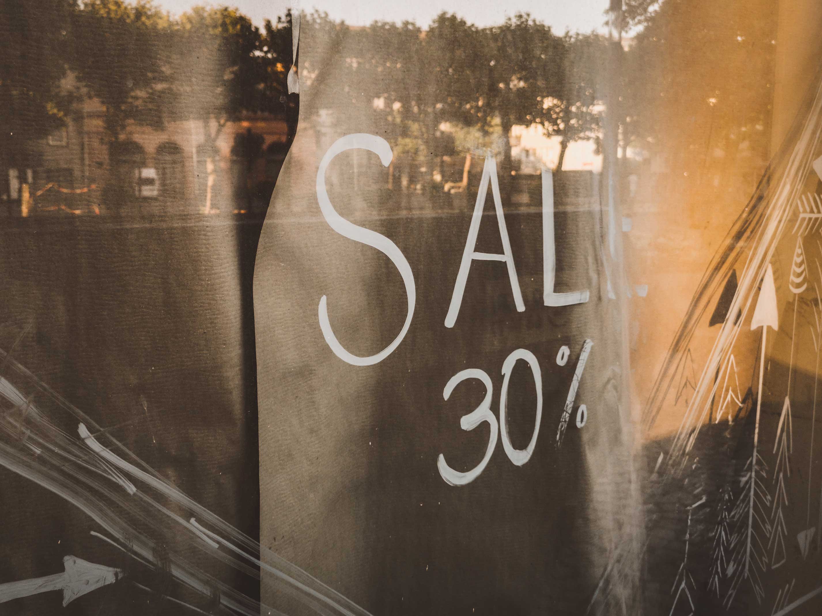 A Simple How to Pricing Guide for Freelance Web Designer|| A sale sign in a store window