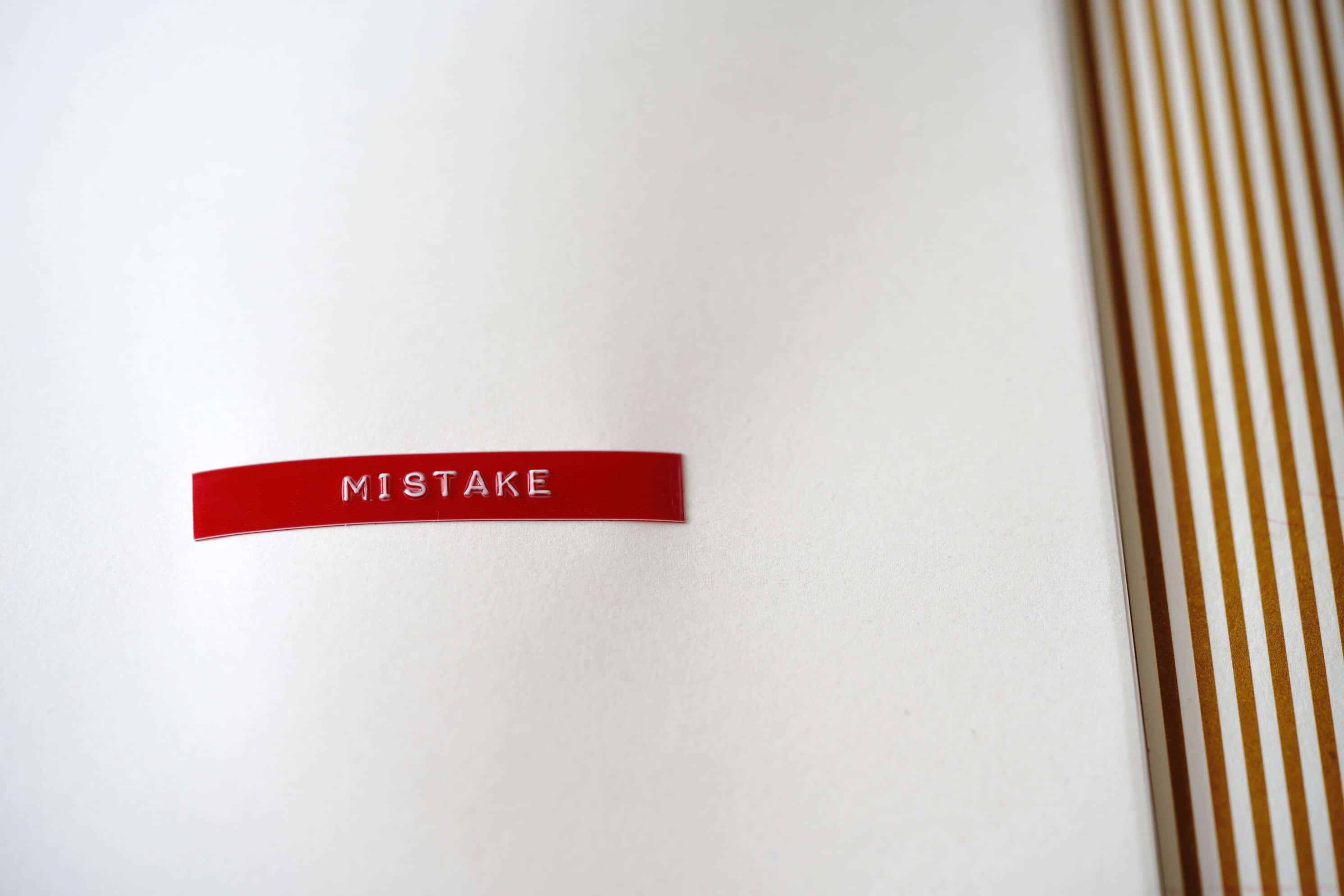 The 5 Worst Mistakes Freelance Web Designers Make and How to Avoid Them || a paper with a sticker on it that says Mistake