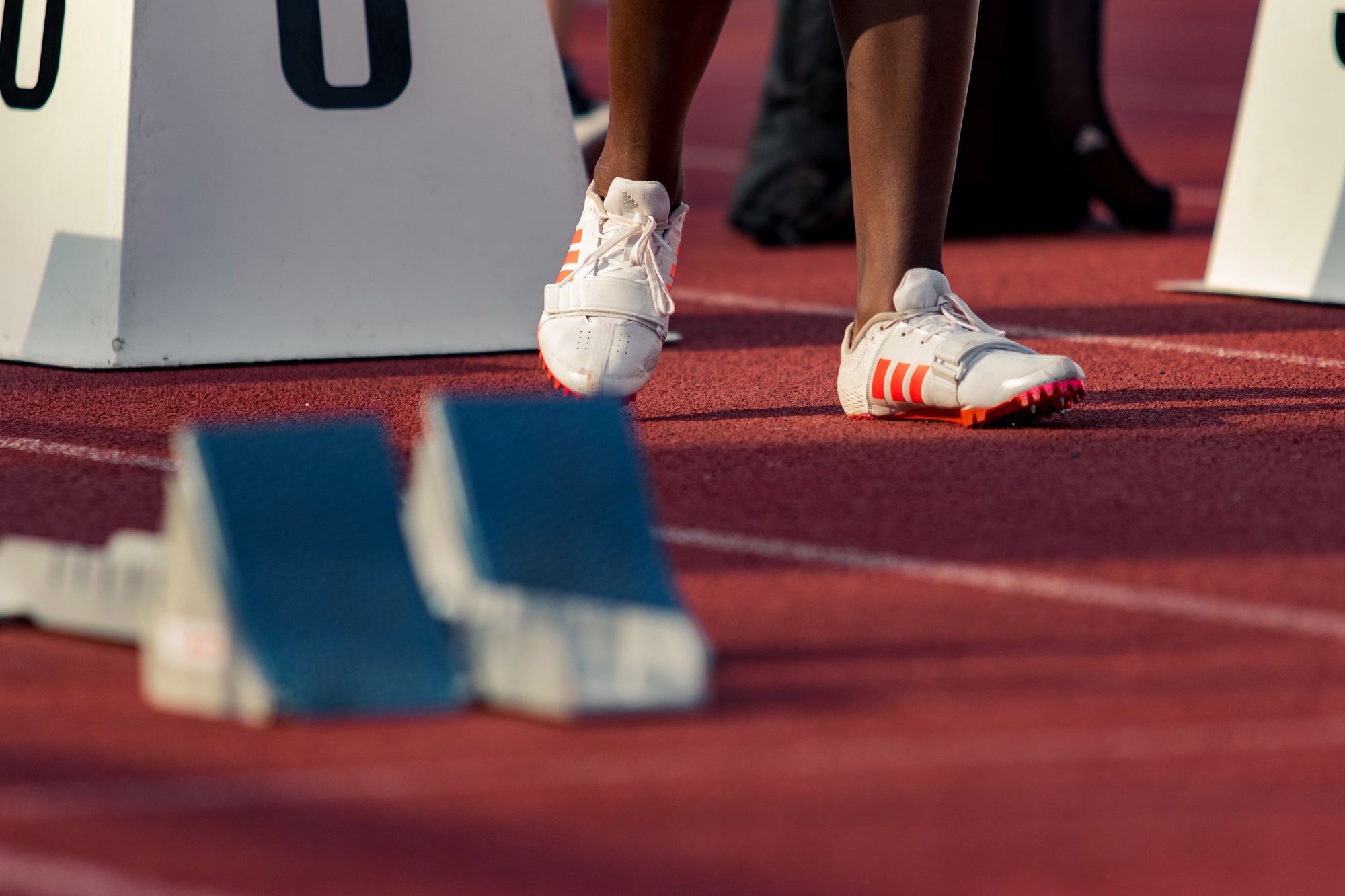 Starting blocks on track to represent how to start a web design business from scratch