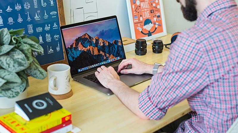 A freelancer at his desk to symbolize winning $10,000 projects as a freelance web designer