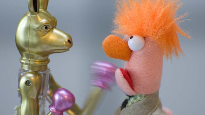 Meeper from the Muppets and robot toy fighting to symbolize handing client objections