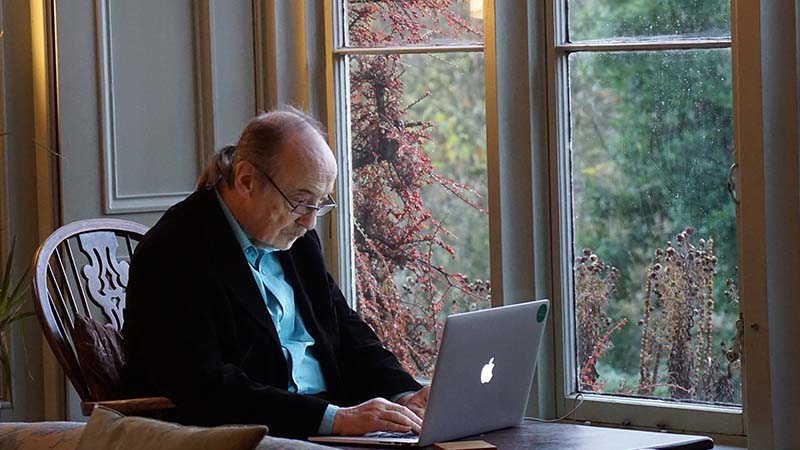 Old man on a computer to symbolize how to break into a web development career after 30